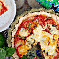 Fresh savory tomato pie topped with cheese, garlic and basil - The Foodie Affair