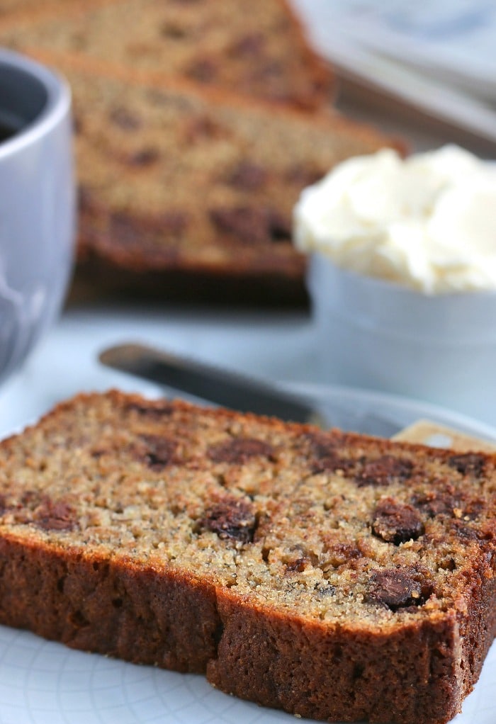 Here we see a slice of the delicious banana bread with chocolate chips ready to be enjoyed. 