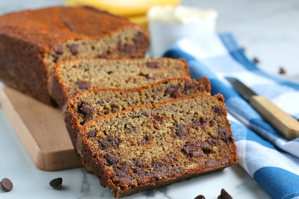 Here we see the loaf of banana bread with slices on one end, ready to be served. 