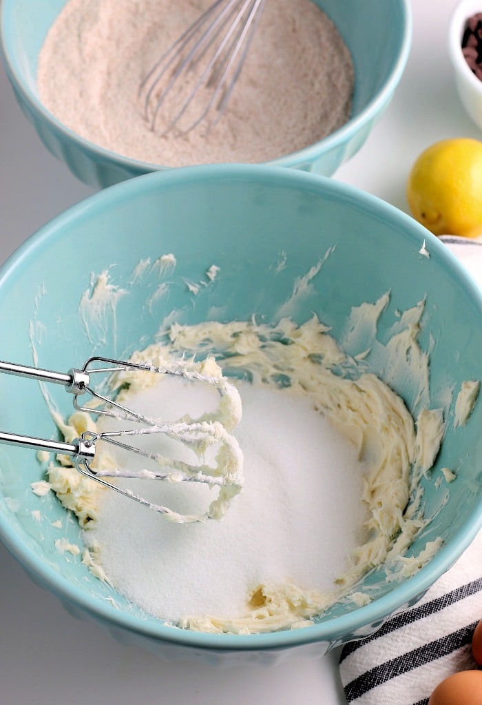 The sugar is added to the bowl in this photo so we can see how it is mixed with the butter for our recipe for banana bread. 