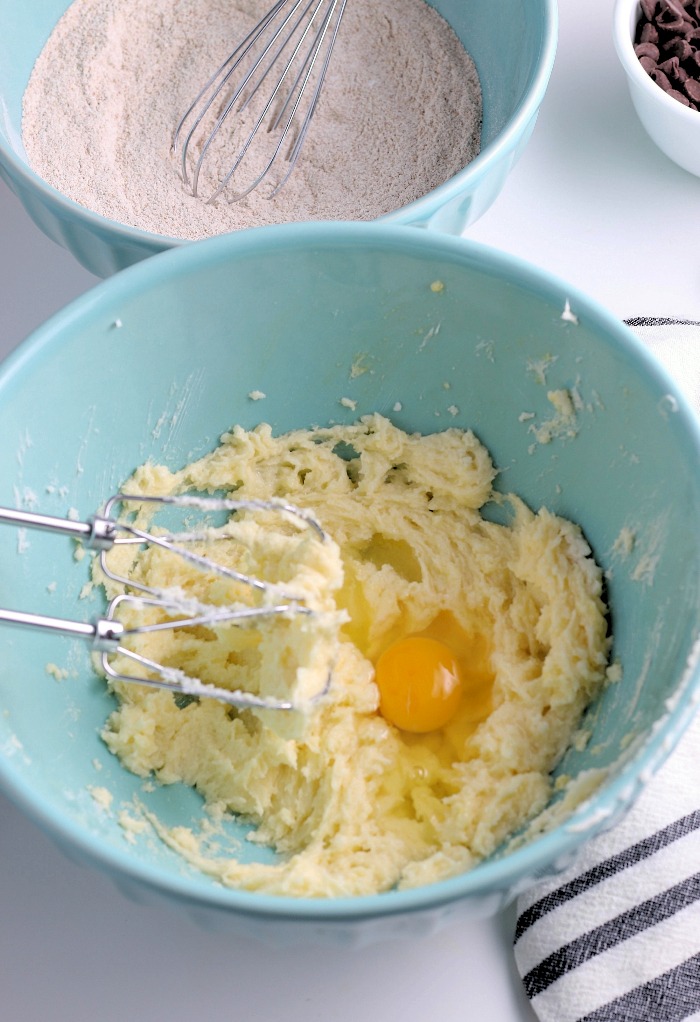 This image shows the eggs being added to the mixture for our chocolate chip banana bread recipe. 