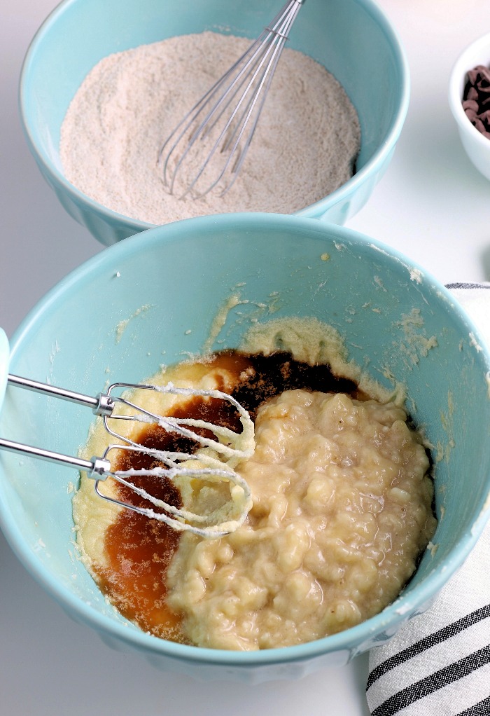 Here we see more wet ingredients being added to the batter for our easy banana bread with chocolate chips. 