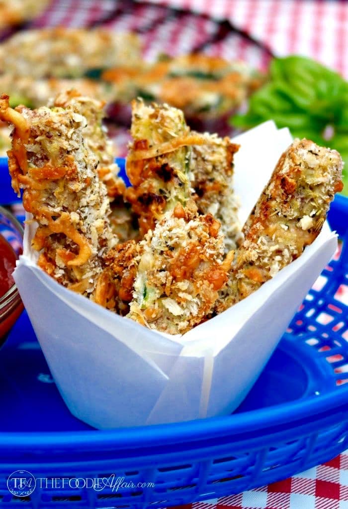 Baked zucchini sticks in a blue serving basket
