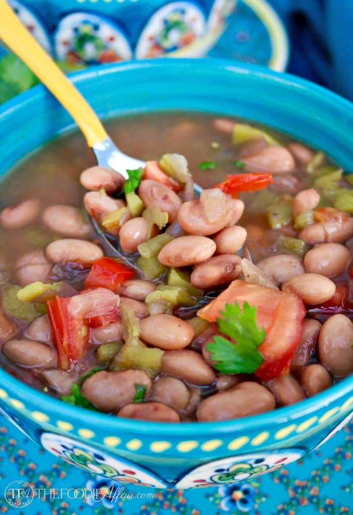 Teal bowl of Mexican pinto beans crock pot recipe 