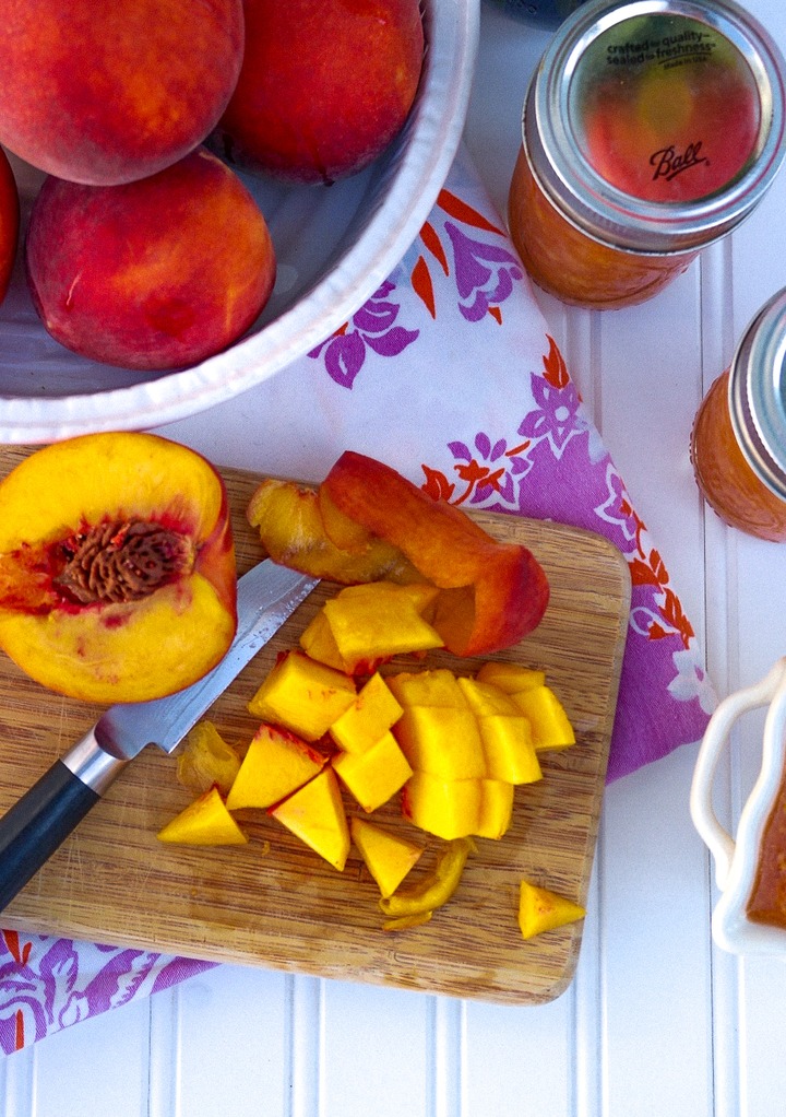 Diced peaches on a cutting board.