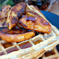 Close up waffles topped with apples.