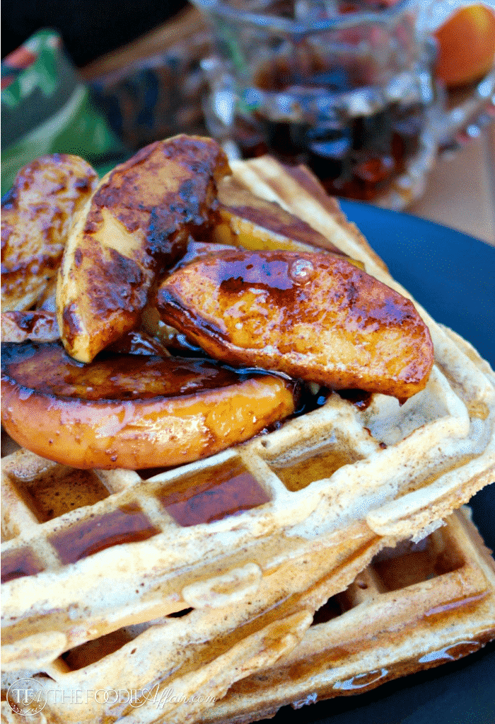 Close up waffles topped with apples.