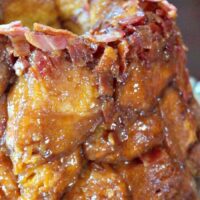 Close up shot of maple bacon monkey bread oozing with a caramel sticky sauce.