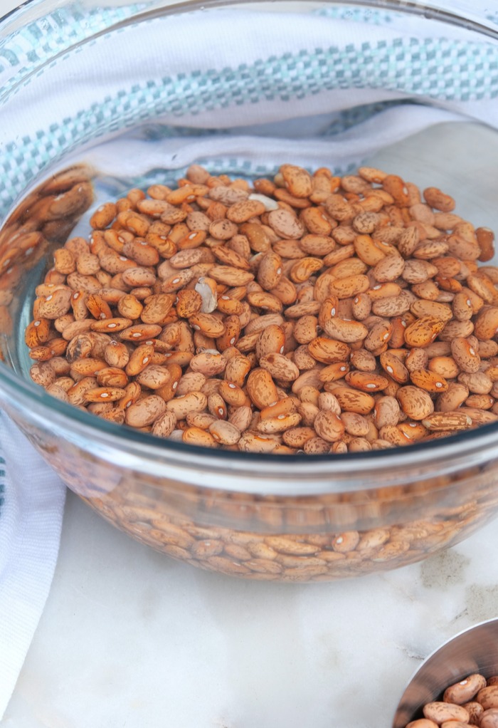 Soaking beans in a clear mixing bowl with water. 