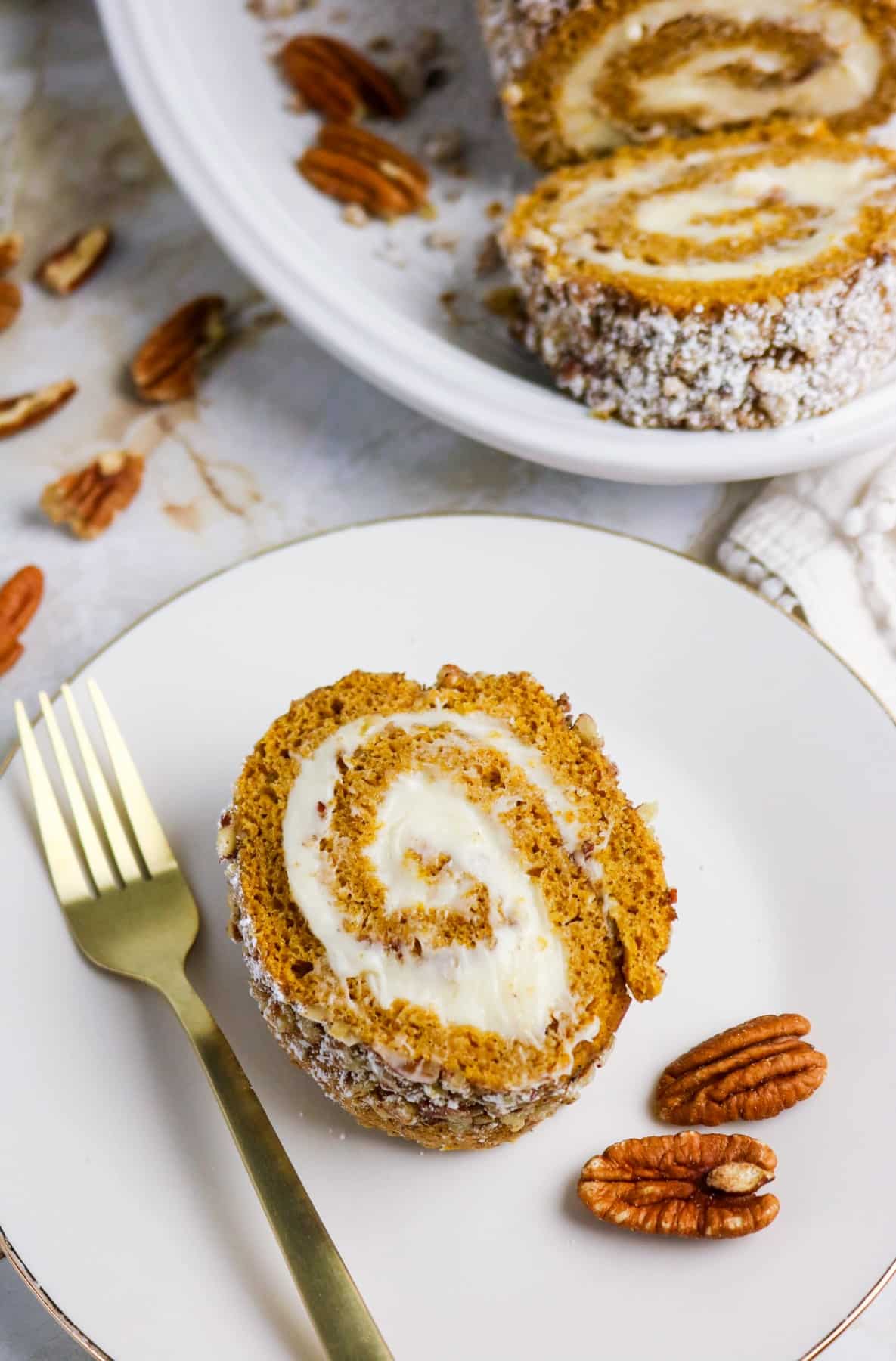 Overhead view of sliced pumpkin roll cake.