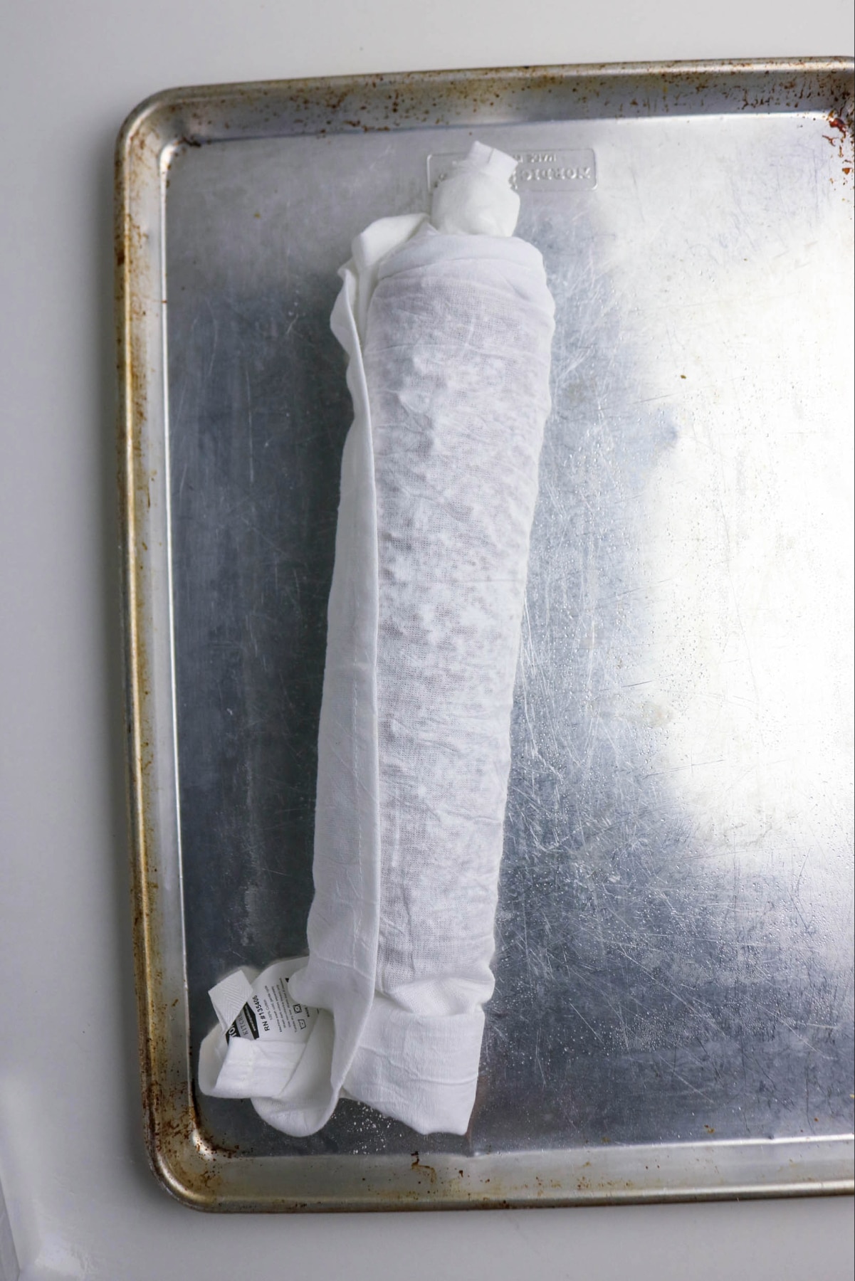 Pumpkin cake rolled in a clean towel sprinkled with powdered sugar.