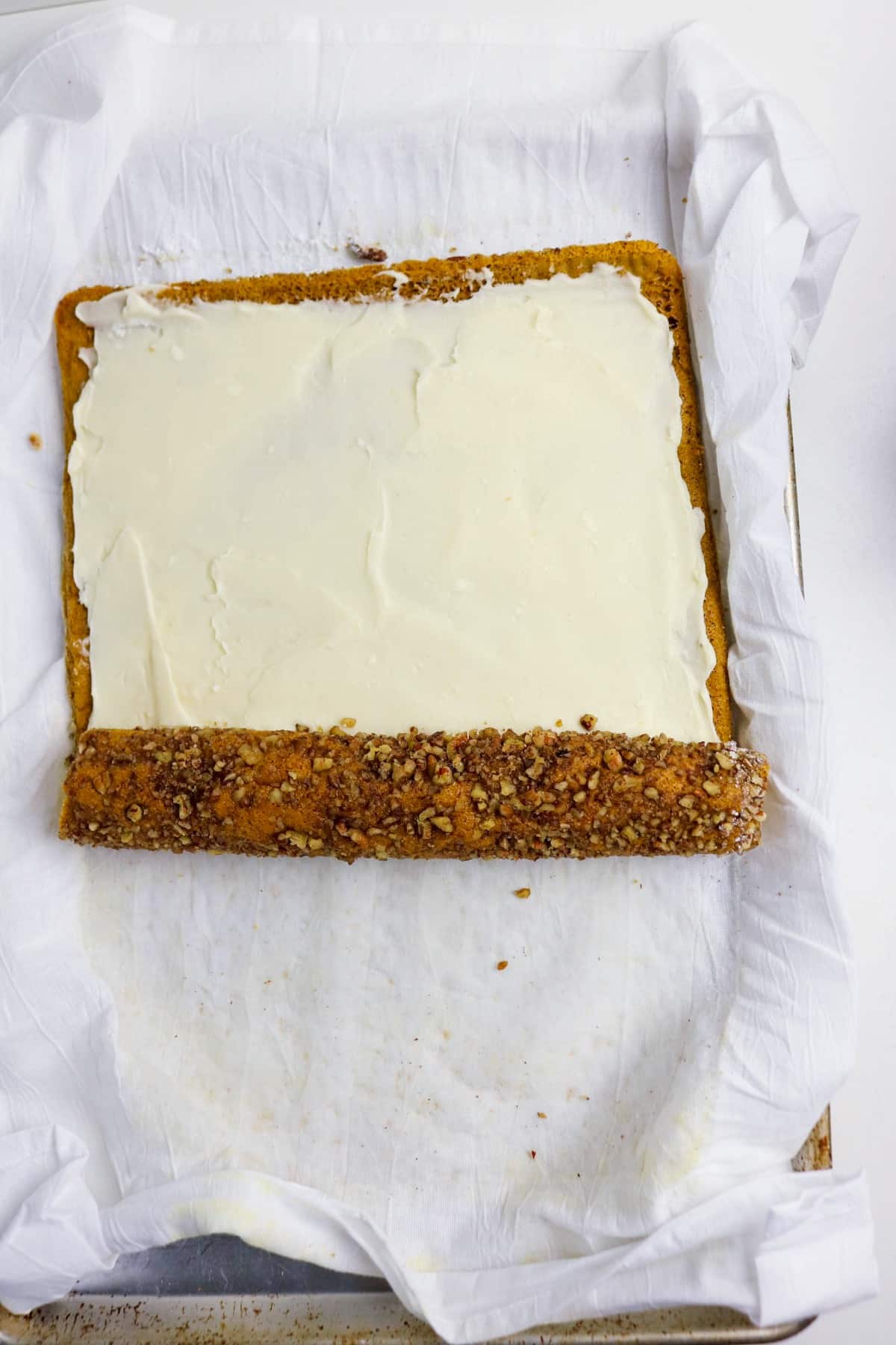 Pumpkin roll cake with cream cheese filling before rolling and decorating.