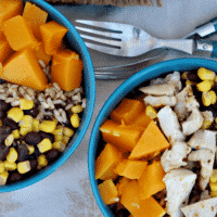 Healthy Quinoa Burrito Bowl layered with Butternut squash, black beans, corn and chicken.