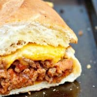 This Bacon Cheeseburger Stuffed French bread on a baking sheet