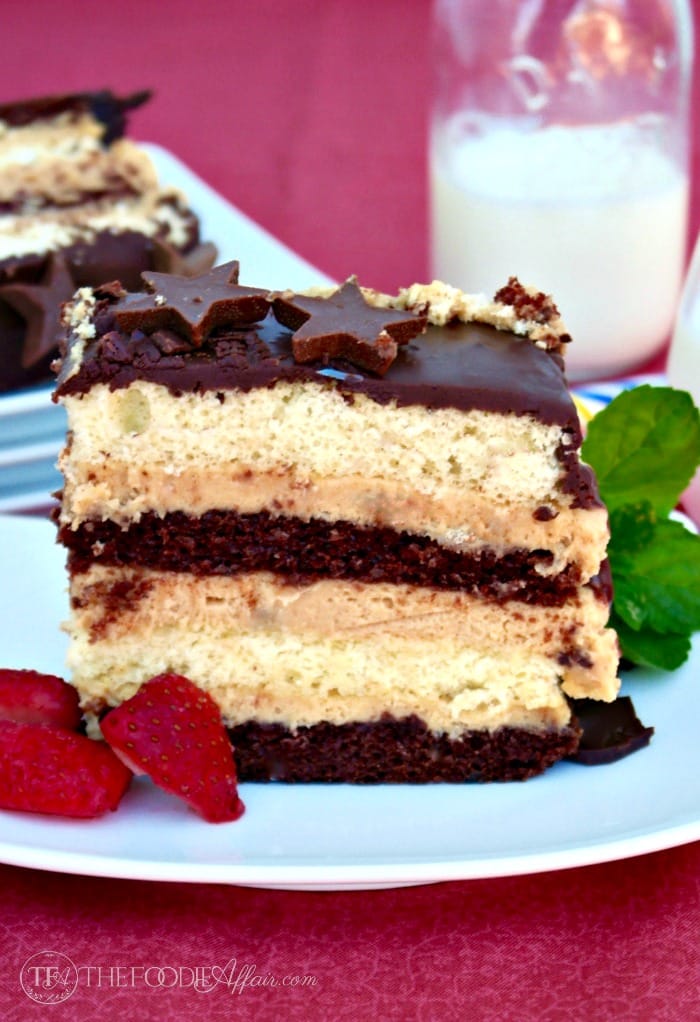 This Peanut Butter Mousse Cake has multiple cake layers with a peanut butter filling and then topped with ganache! Decadent dessert for any special occasion! The Foodie Affair