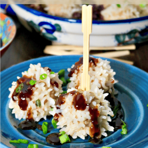 Pork Rice Balls Recipe on a blue plate topped with hoisin sauce.