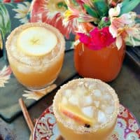 Apple cider margarita in a clear sugar rimmed glass.