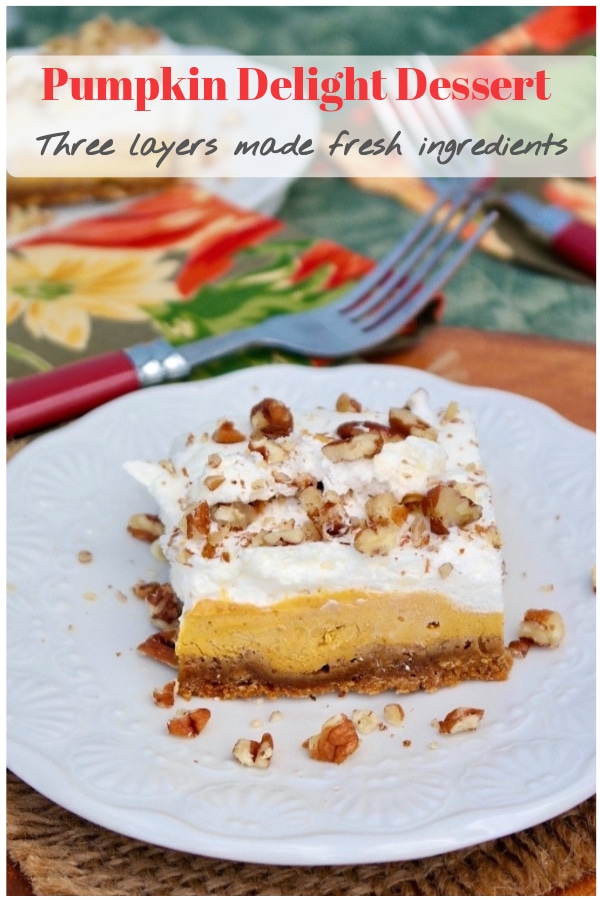 Light and airy pumpkin delight dessert is three layers of delicious Fall flavors: gingersnap crust, creamy pumpkin filling with cream cheese, and fresh whipped cream all topped with chopped pecans! #dessert #fall #pumpkin #partyidea #realingredients #thefoodieaffair