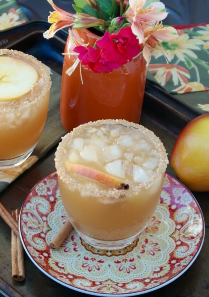 Clear glass with fall margarita cocktail for Thanksgiving on a decorative plate. 