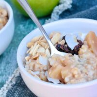 A white cereal bowl with apple cinnamon oatmeal ready to be enjoyed.