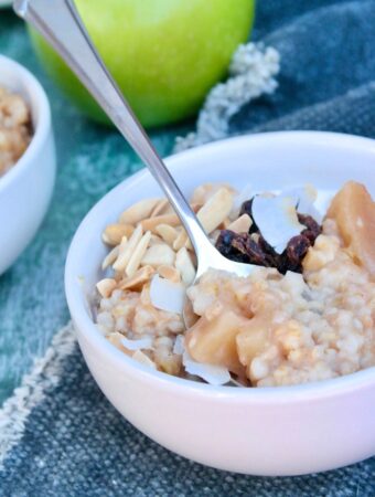 A white cereal bowl with apple cinnamon oatmeal ready to be enjoyed.