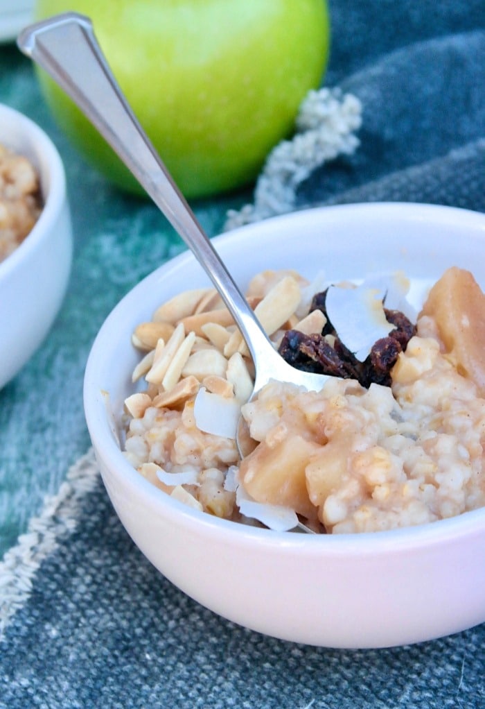 A white cereal bowl with apple cinnamon oatmeal ready to be enjoyed. 