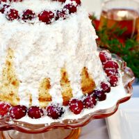 Vanilla Chiffon Cake with Sugared Cranberries on a cake plate