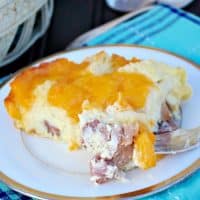 Gooey cheesy overnight ham egg casserole is sure to please a crowd! Make this a day ahead for easy entertaining! The Foodie Affair