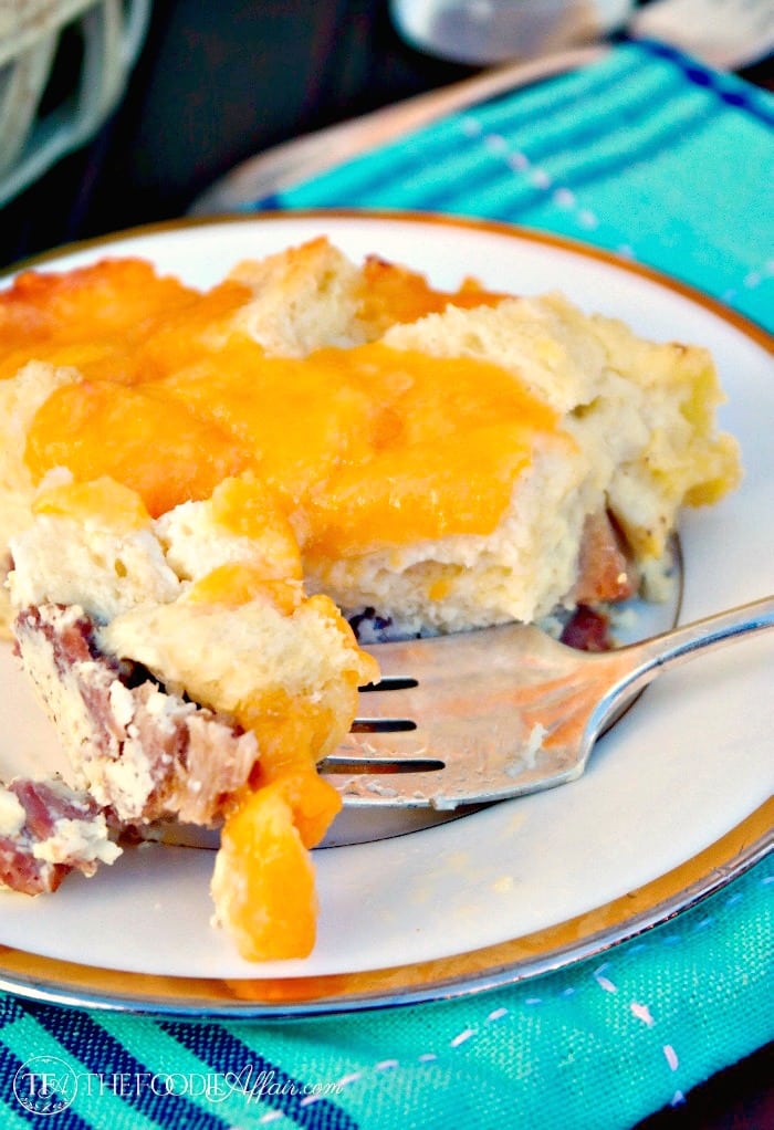 Gooey cheesy overnight ham egg casserole is sure to please a crowd! Make this a day ahead for easy entertaining! The Foodie Affair