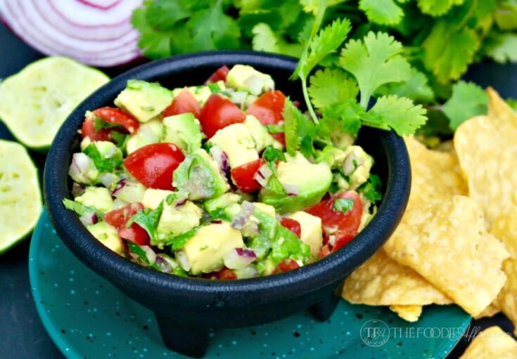 avocado dip in a small black salsa dish