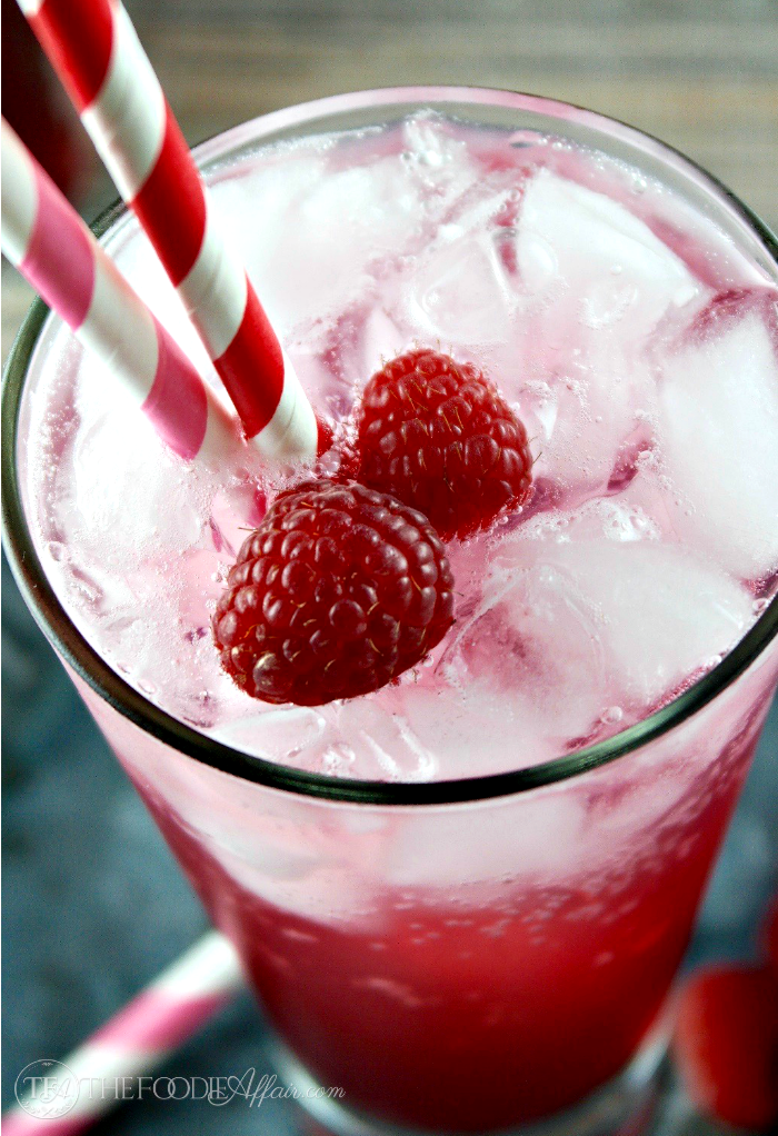 Italian Soda with red and pink straws and fresh berries