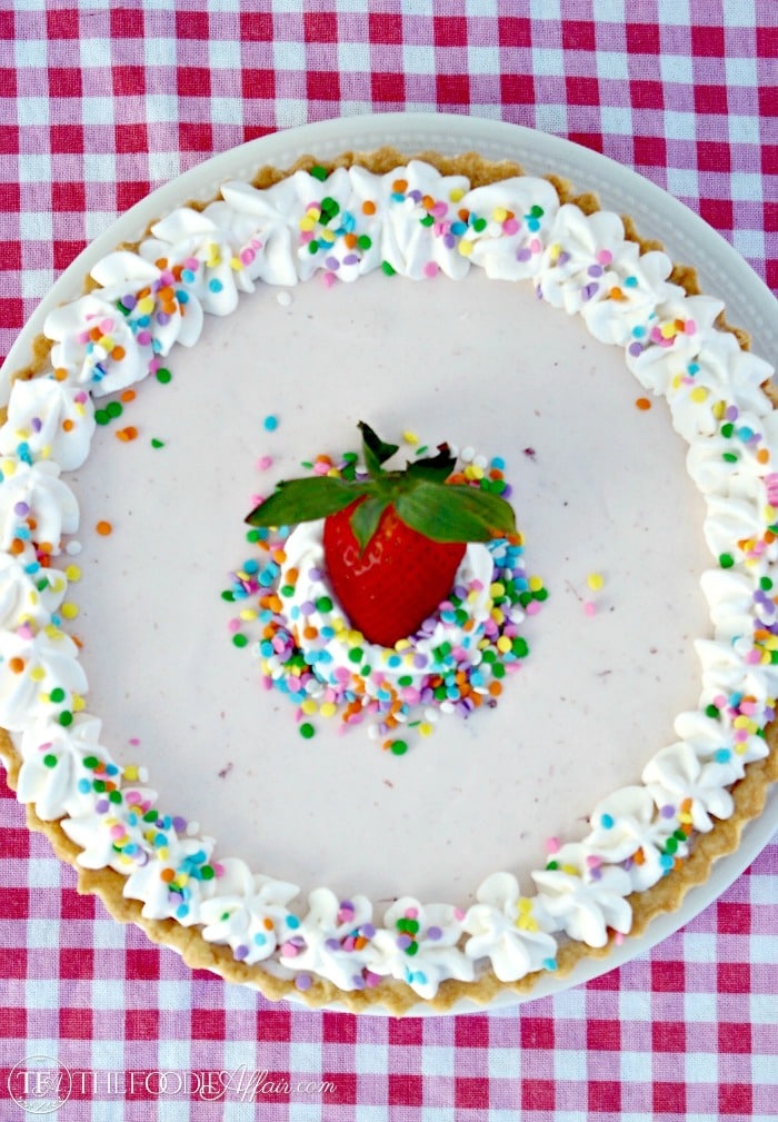 Shortbread Ice Cream Cookie Cake has a think layer of chocolate separating the crust from the ice cream! This tasty dessert can be sliced and eaten with your hands! The Foodie Affair
