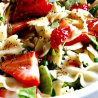 Strawberry Spinach Pasta Salad in a large white serving bowl