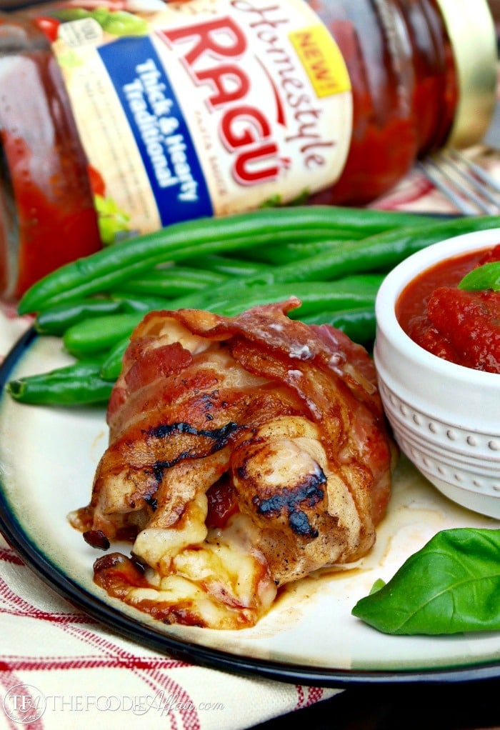 Bacon wrapped chicken on a white plate