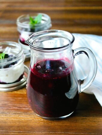 Homemade blueberry sauce in a glass decanter