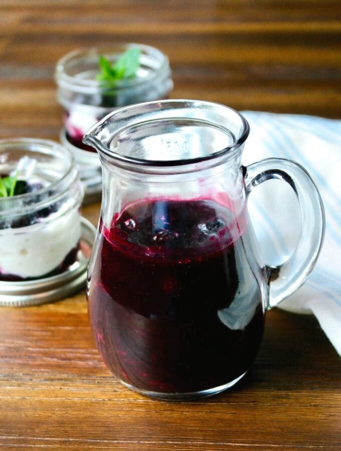 Homemade blueberry sauce in a glass decanter