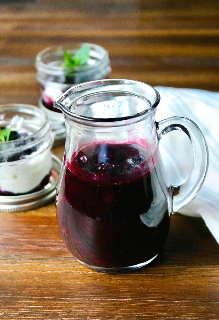 Homemade blueberry sauce in a glass decanter