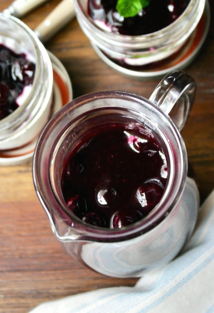 Overhead view of blueberry sauce in a glass jar