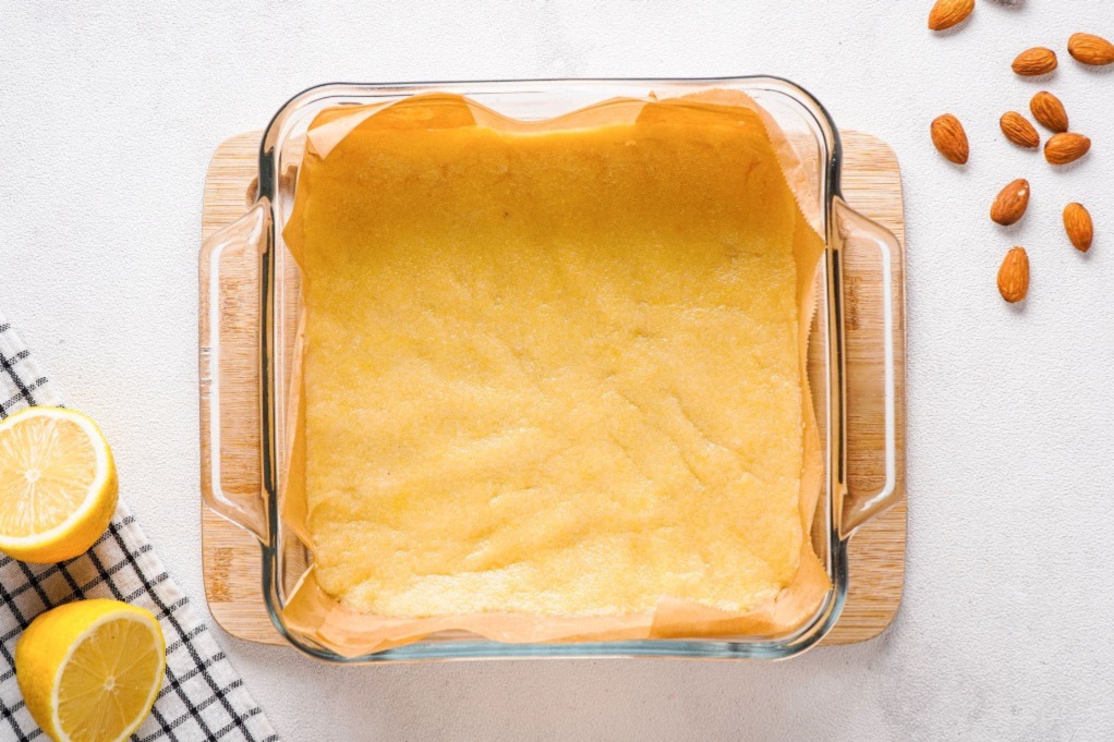 Parchment lined baking dish with the crust before baking.