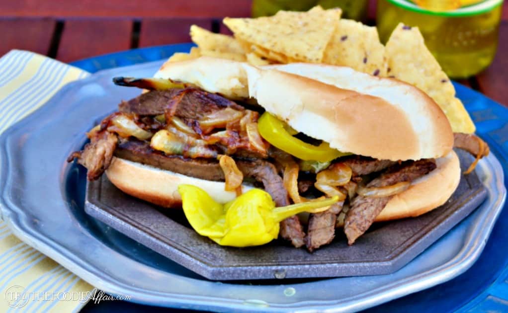 Cheese Steak Sandwich traditional Philly-style with beef, grilled onions, and melted cheese! Elevate the flavor with jalapeno peppers and peperoncinis! 