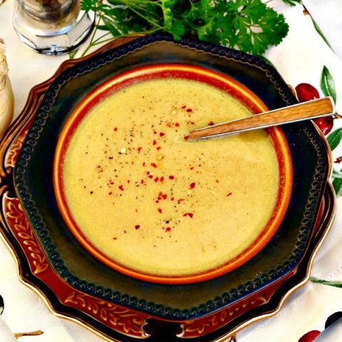 Creamy cauliflower soup with a sprinkle of red peppers