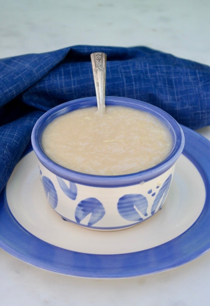 Homemade sugar free sweetened condensed milk in a blue and white bowl. 