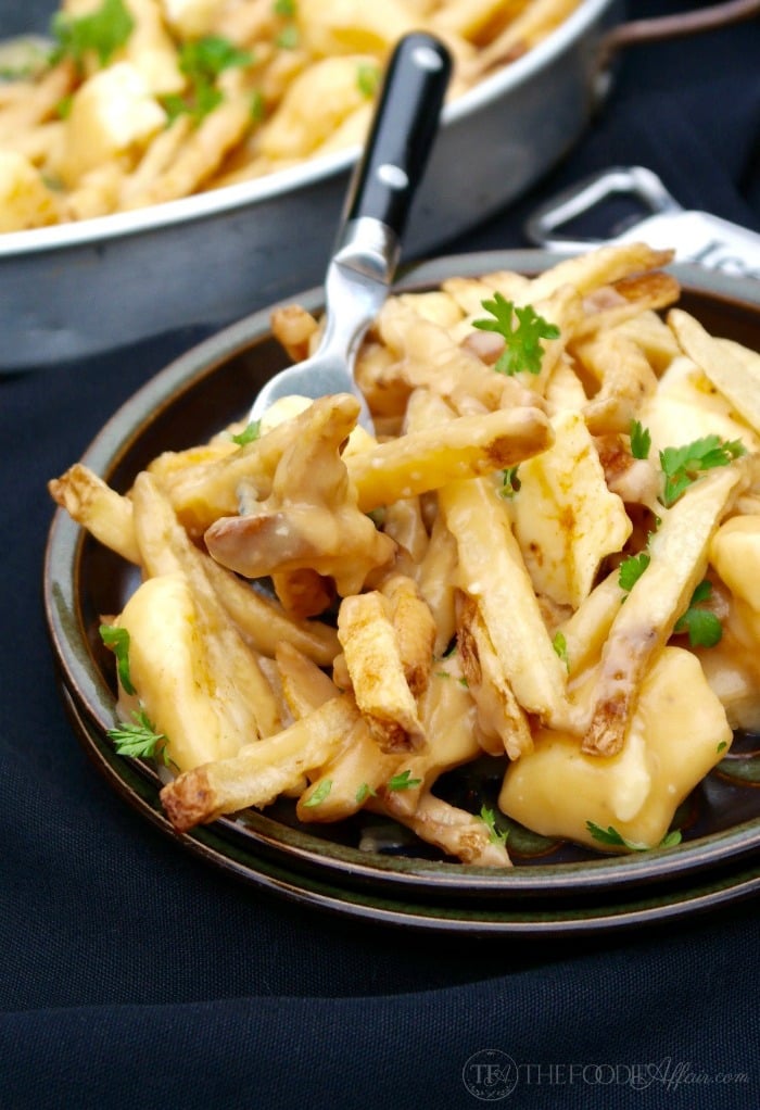 French-Canadian Poutine dish is made of French fries, cheese curds and light brown gravy! Flavorful and easy to make when you use pre-made fries! 