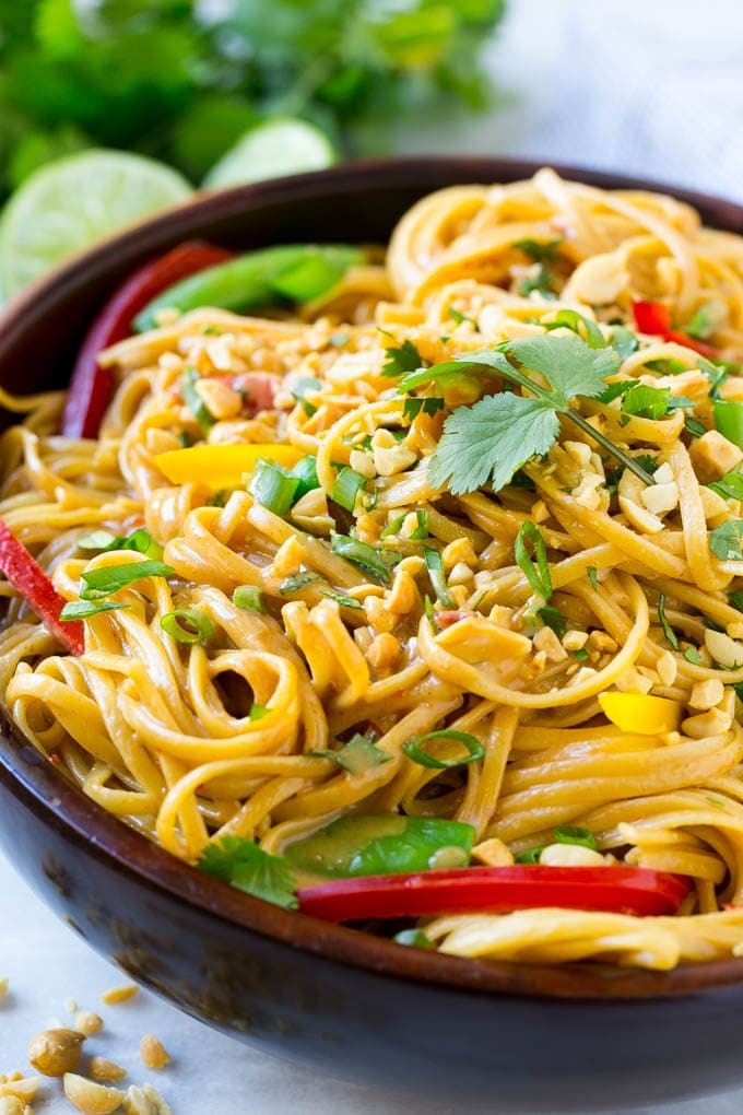 Thai peanut noodle Dish in a dark bowl ready to eat. 