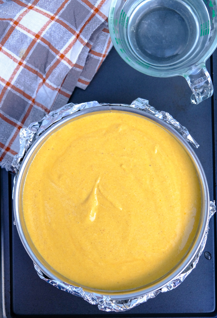 Top view of cheesecake filling in a water bath.