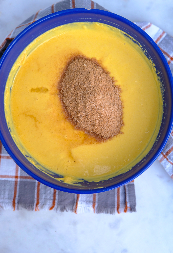 Dry ingredients added to the wet ingredients for pumpkin cheesecake recipe.