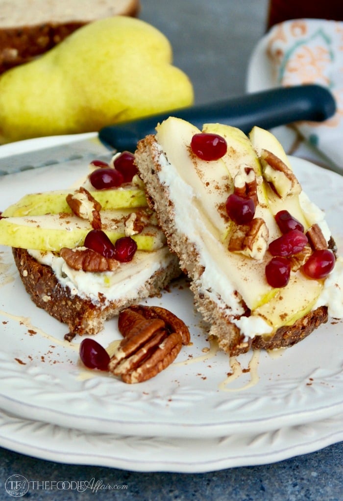 Ricotta toast with pears and pecans on a white plate