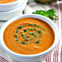 Carrot soup with curry in a white bowl
