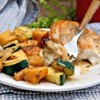 Chicken and butternut squash on a white dinner plate