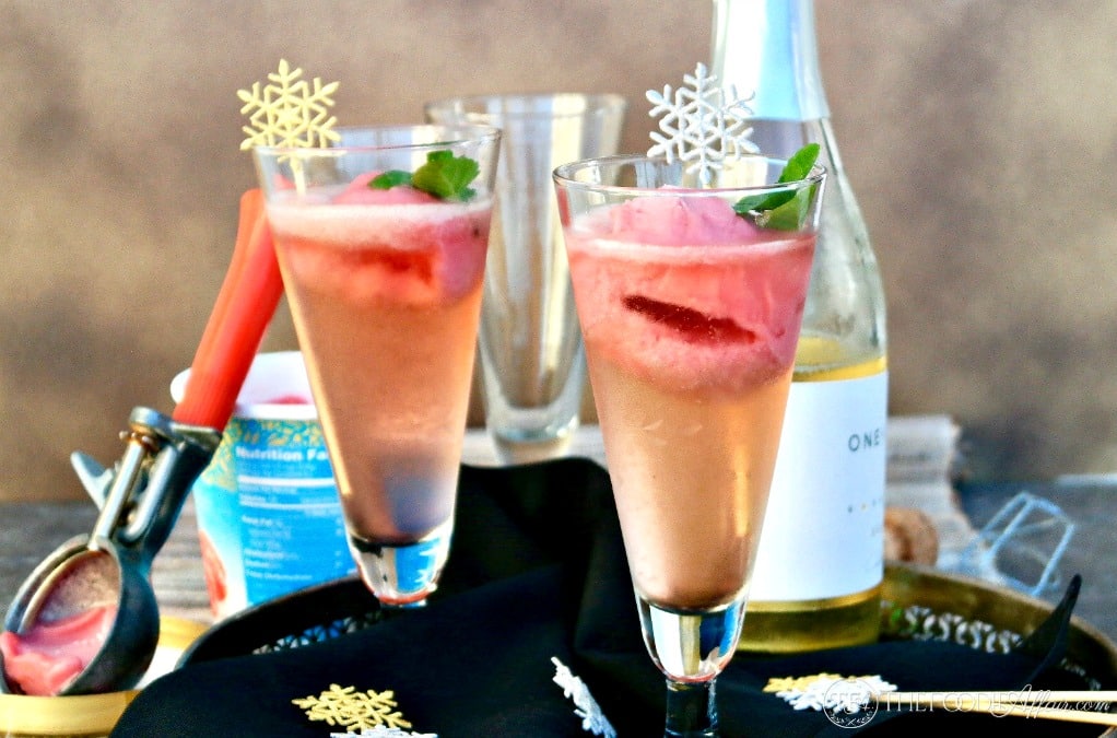 Raspberry Prosecco Cocktail (Sgroppino)on a tray with prosecco in the background